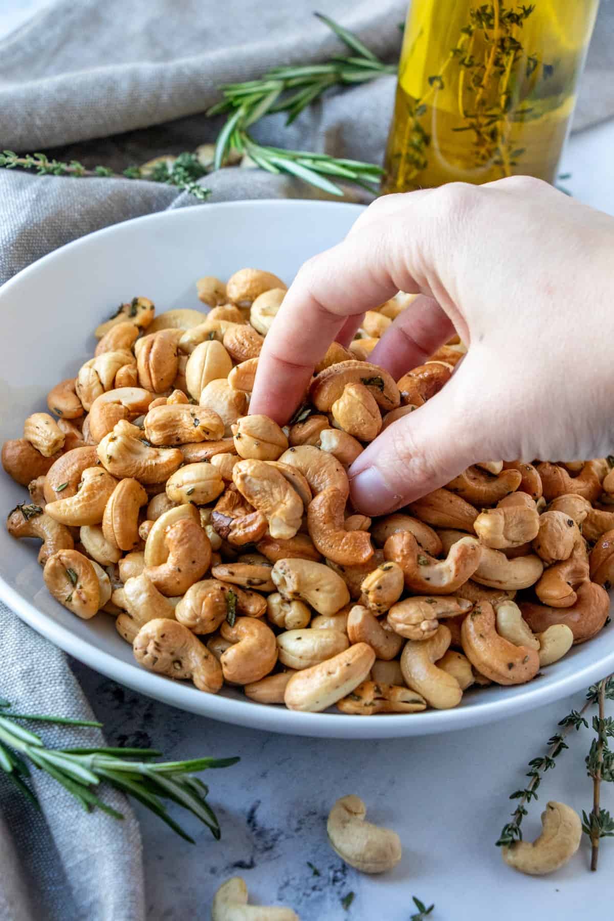 Herb-Roasted-Cashews-grabbing-some-out-of-a-bowl17-Custom